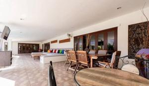 a living room with a couch and a table at Baan Katthaliya in Hua Hin