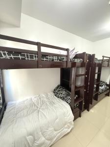 two bunk beds in a room with a bed at Blanc Suite in Dasmariñas +2 photos