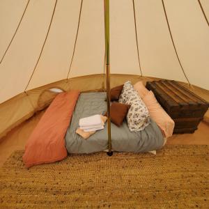 a bed in a tent with pillows on it at Alaskan Glamping in Anchorage