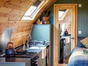 a kitchen with a stove and a sink in a cabin at Swallow - Uk51347 in Draughton