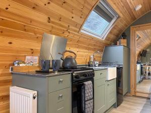 a kitchen with a stove with a tea kettle on it at Swallow - Uk51347 in Draughton