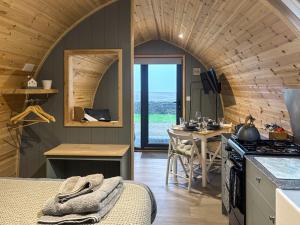 a kitchen and dining room in a tiny house at Swallow - Uk51347 in Draughton +15 photos