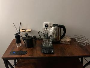 a wooden table with a coffee maker and glasses on it at روڤان in Hafr Al-Batin