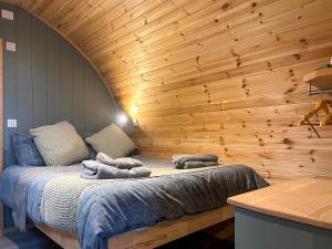 a bed in a room with a wooden wall at Swallow - Uk51347 in Draughton