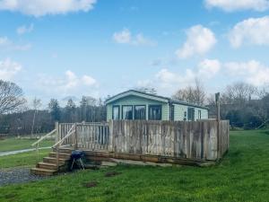 a tiny house in a field with a fence at Oak Tree Lodge - Uk51429 in Westward