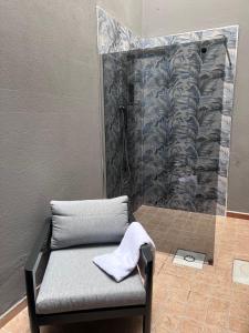 a shower with a bench in front of a shower stall at NoveQuattro Apartment in Cagliari