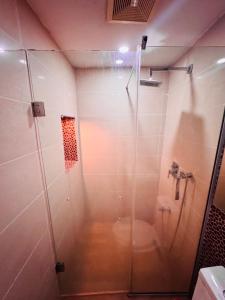 a bathroom with a shower with a toilet in it at Liberty Suite - Abuja in Abuja