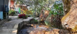 a small stream of water in front of a building at lnthanon Laoju เล่าจู in Ban Na Yang