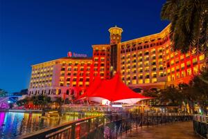 a hotel with a red tent in front of a building at Ramada By Wyndham Huizhou South in Huizhou