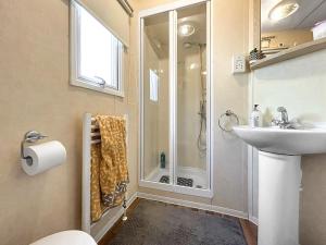 a bathroom with a shower and a sink at Wah Caravan in Dundee +2 photos