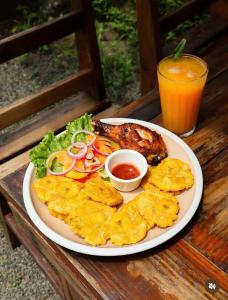 a plate of food with meat and chips and a drink at Hostel, Café & Garden Travelers in Santiago