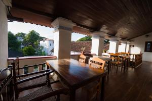 a wooden table and chairs on a patio at Old Courtyard Hotel in Cochin