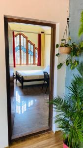 a mirror reflection of a bedroom with a bed in a room at Celestial Homestay in Wayanad +8 photos