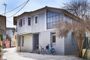 two bikes parked in front of a white house at eliamaria artistic house in Lefkada