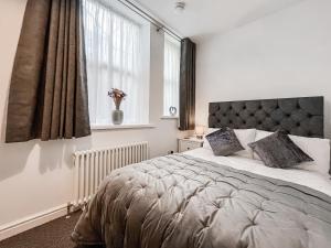 a bedroom with a large bed and a window at Old Steamship Quarters in Whitby