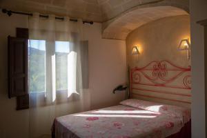 a bedroom with a bed and a window at Hotel Baglio Catalano in Custonaci