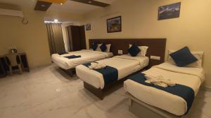 a hotel room with two beds with towels on them at Sky Loft near Kempegowda International Airport in Muthugadahalli