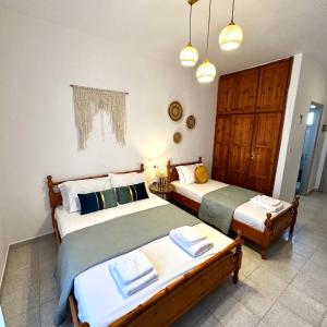 two beds in a room with at Liberty Studio in Kallithea Halkidikis