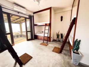 a room with a bunk bed and a ladder at Trinco Beach Bunks in Trincomalee