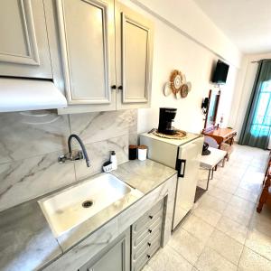 a kitchen with a sink and a counter top at Liberty Studio in Kallithea Halkidikis