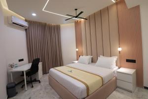 a hotel room with a bed and a desk at Luxury Villa in Falnir in Mangalore
