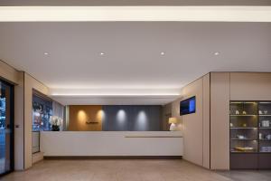 a lobby of a building with a reception counter at Zhangjiajie Homeinn Hotel- New Hotel,Free Breakfast, Free Self-Service Laundry & Drying, Attraction Tickets Serivce in advance,Toursim info in Zhangjiajie