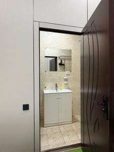 a bathroom with a sink and a mirror at Chinor Garden Hotel - Free Airport Pick-up Yandex Go in Tashkent +131 photos