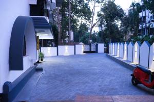 a parking lot with a scooter parked next to a building at Luxury Villa in Falnir in Mangalore
