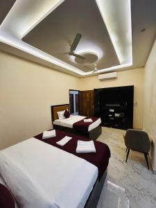 a hotel room with two beds and a fireplace at Hotel DVL INN- Near Jalmahal Jaipur in Jaipur