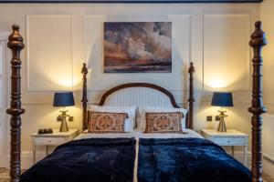 a bedroom with a large bed with two night stands at The Gifford in Edinburgh