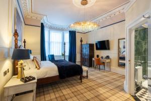a bedroom with a king sized bed and a desk at The Gifford in Edinburgh