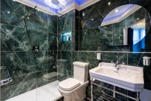 a bathroom with a toilet and a sink and a shower at The Gifford in Edinburgh
