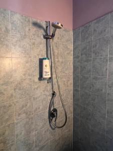 a shower with a shower head in a bathroom at La Rosa dei Monti Iblei in Ferla