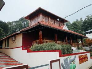 a small building with a roof on top of it at JackRoot Athirappilly in Kallana