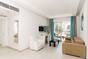 a living room with a couch and a table at Costa Luvi Hotel Bodrum - All Inclusive in Gümbet
