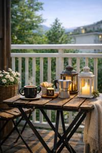 a wooden table with a candle and cups and a lantern at MARY HOUSE Central Station Large Apartment in Sondrio +68 photos