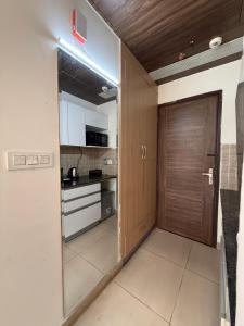 a door leading into a kitchen with a counter at AeroNest Luxe in Zirakpur +4 photos