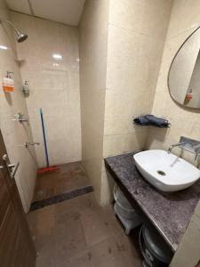 a bathroom with a sink and a toilet and a mirror at AeroNest Luxe in Zirakpur