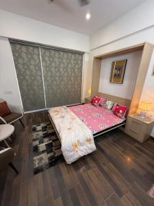 a bedroom with a large bed with a pink blanket at AeroNest Luxe in Zirakpur