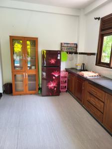 a kitchen with a refrigerator and a sink at Villa Olive in Hikkaduwa +1 photo