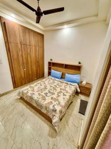a bedroom with a large bed with blue pillows at Mokshika Homes at Rishikesh in Birbhaddar