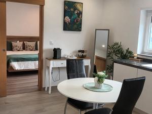 a living room with a table and a bedroom at Panorama Douro House in Armamar