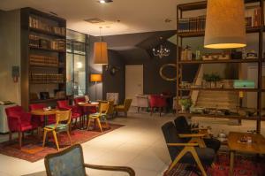a restaurant with tables and chairs in a room at Hotel Sliško in Zagreb