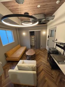 a living room with a couch and a table at HOTEL919Otemachi in Hiroshima