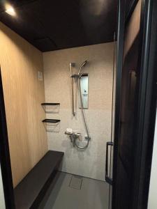 a bathroom with a shower and a mirror on the wall at HOTEL919Otemachi in Hiroshima