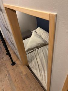 a small bed in a corner of a room at HOTEL919Otemachi in Hiroshima