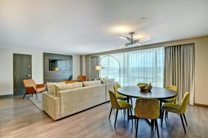 a living room with a couch and a table at Tulsa Marriott Southern Hills in Tulsa