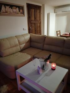 a living room with a couch and a table with wine glasses at Chata Borecké skály in Ktová
