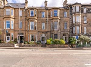 an empty street in front of a large brick building at The Gifford in Edinburgh