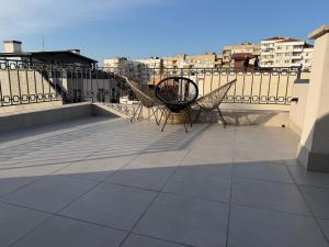a pair of chairs sitting on a balcony at Luxury flat 2 in Pleven